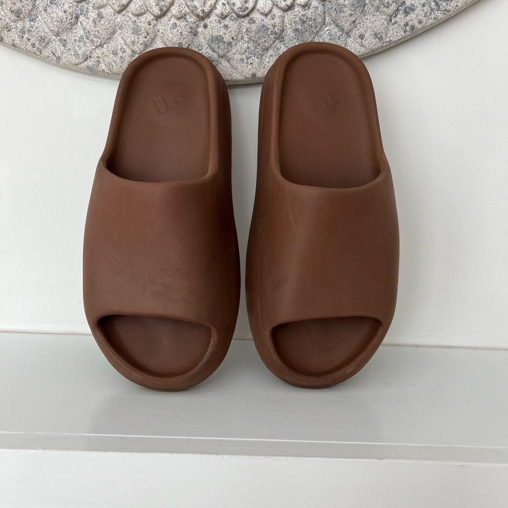 Yeezy slides flax, size 10, well worn, and no box. Shoe fits small
